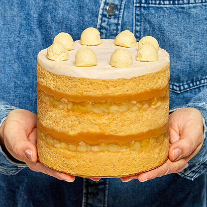 Side view close-up shot of the limited-edition Caramel Apple Pie Cake being presented in a persons hands.