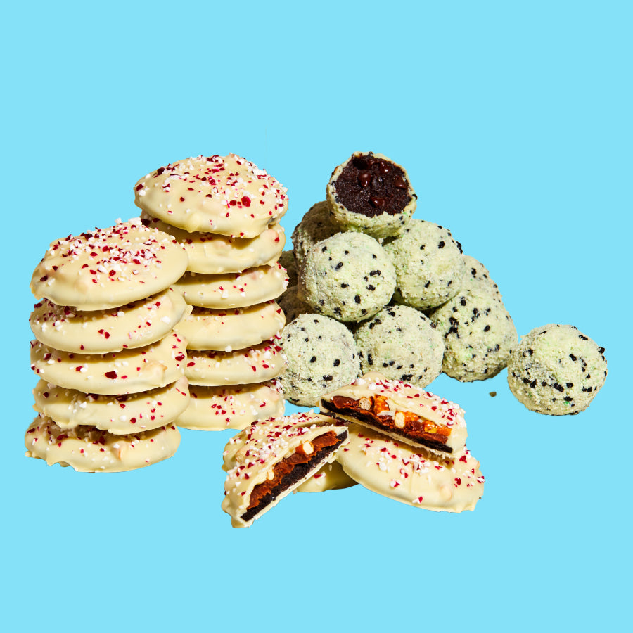 A stack of mini peppermint bark snap cookies and a pile of Chocolate Mint Chip Cake truffles.