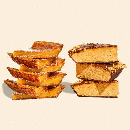 A stack of milk bar pie slices beside a stack of chocolate peanut butter crunch pie slices