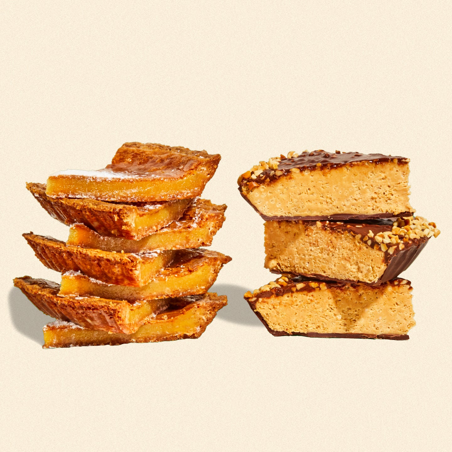 A stack of milk bar pie slices beside a stack of chocolate peanut butter crunch pie slices