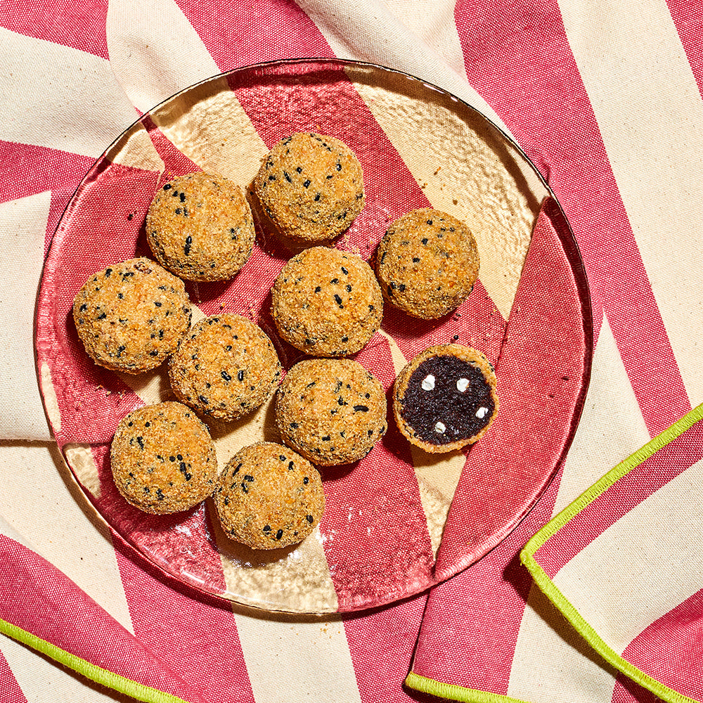 overhead view of a see-through plate of s'mores cake truffles on an outdoor table in the sun