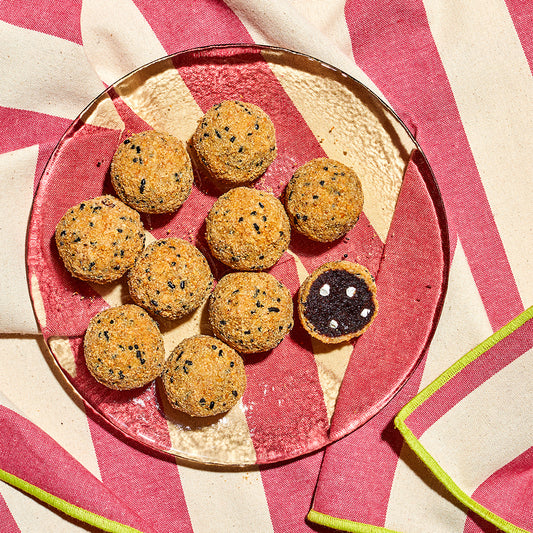 overhead view of a see-through plate of s'mores cake truffles on an outdoor table in the sun