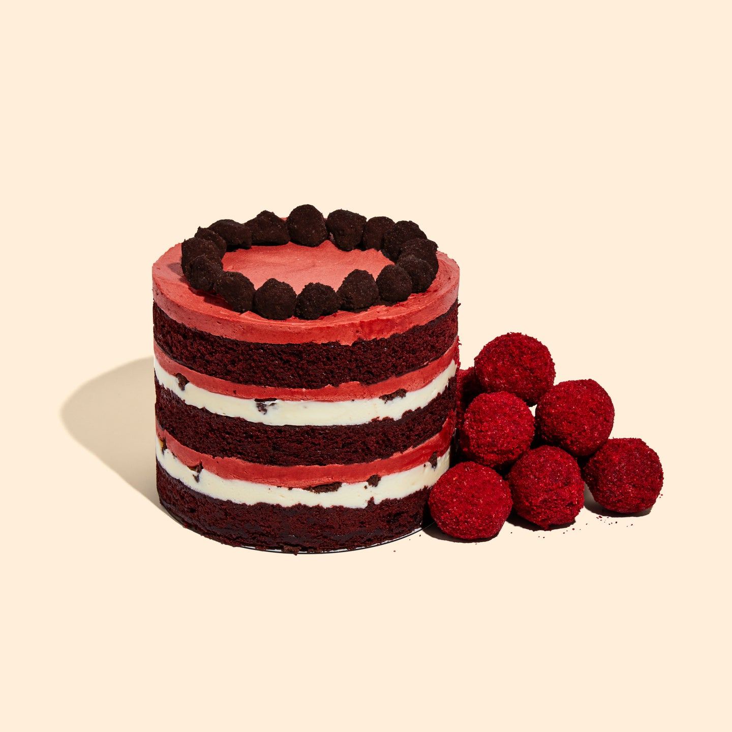 A pile of Red Velvet Cake Truffles sitting beside the 6