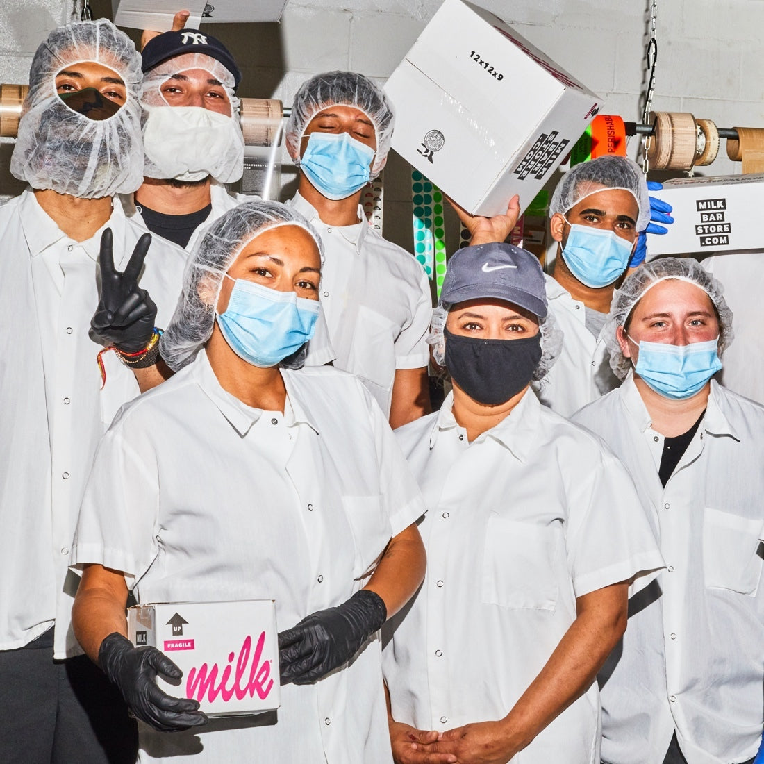 Milk Bar's back of house team gathering together for a group photo in the kitchen.